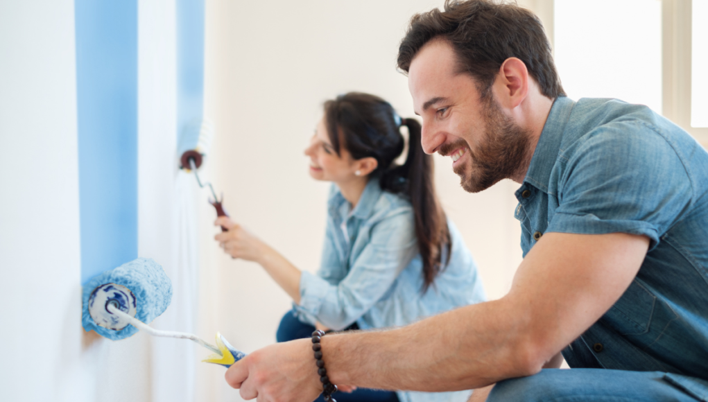 couple painting the wall diy c 211223